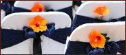 Link to wedding page. The image is a of flowers on the back of a chair.